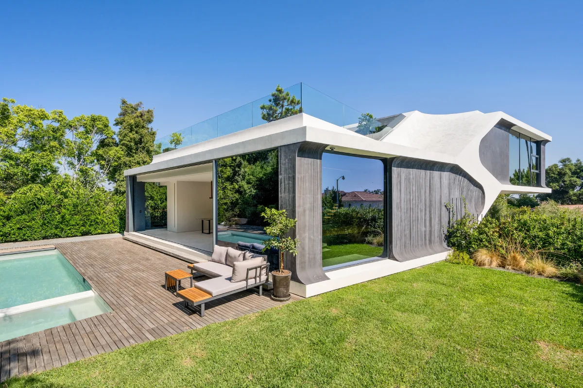 the-view-of-the-backyard-with-pool-and-loungers.webp